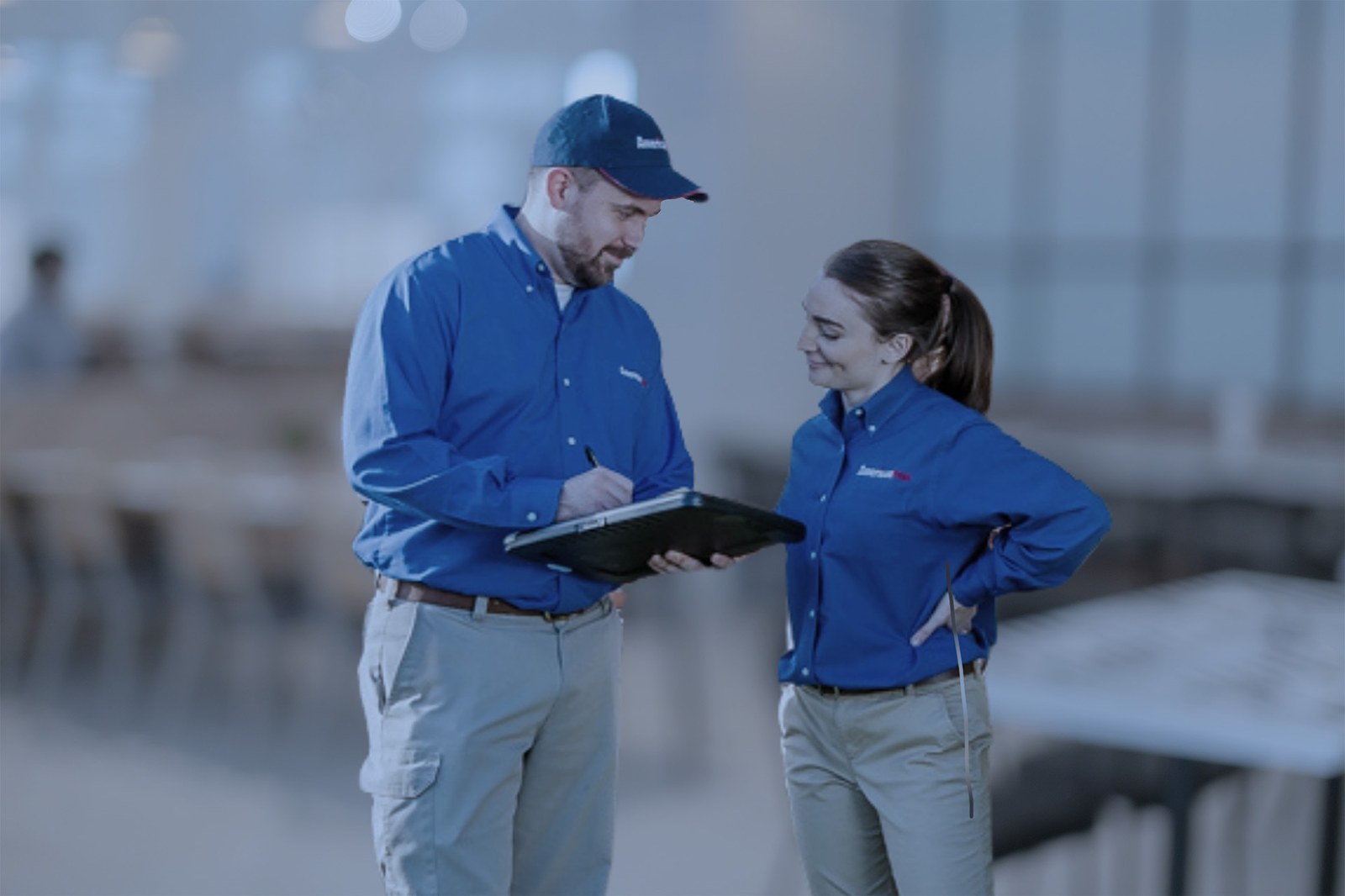Two American Pest professionals reviewing a commercial pest control plan