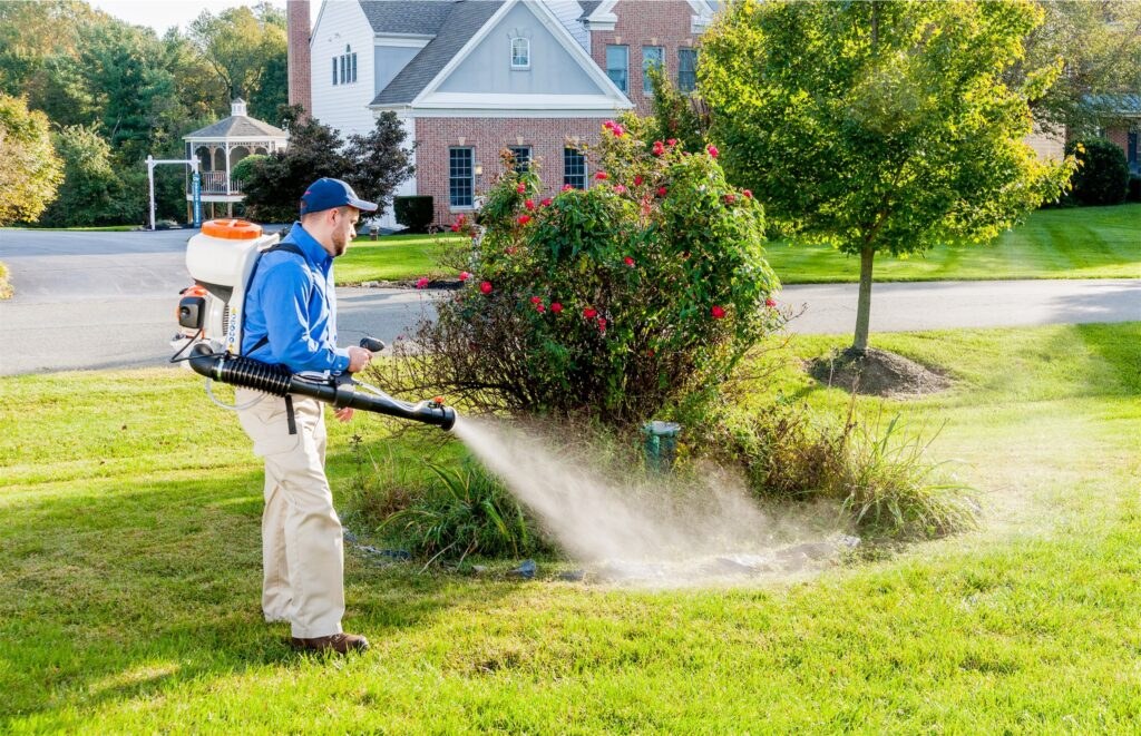 An American Pest technician misting a yard for mosquito control