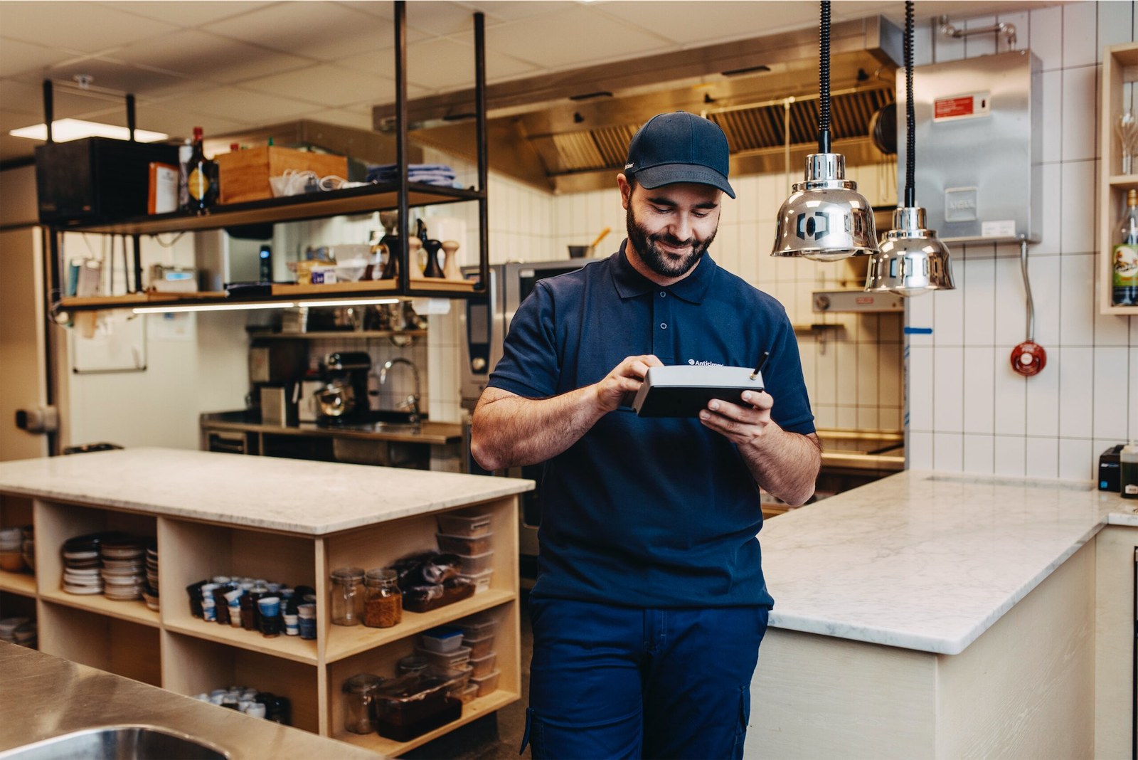 An American Pest technician inspecting pantry shelves
